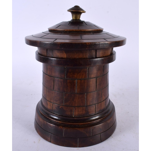 669 - AN UNUSUAL 19TH CENTURY TREEN CASTLE TURRET TEA CADDY AND COVER. 15cm x 8 cm.