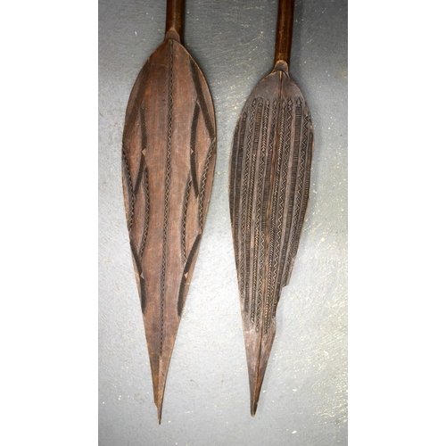 685 - TWO AFRICAN TRIBAL CARVED WOOD PADDLES one decorated with animals, the other with motifs. 160 cm lon... 