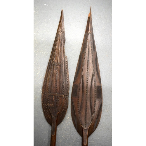 685 - TWO AFRICAN TRIBAL CARVED WOOD PADDLES one decorated with animals, the other with motifs. 160 cm lon... 