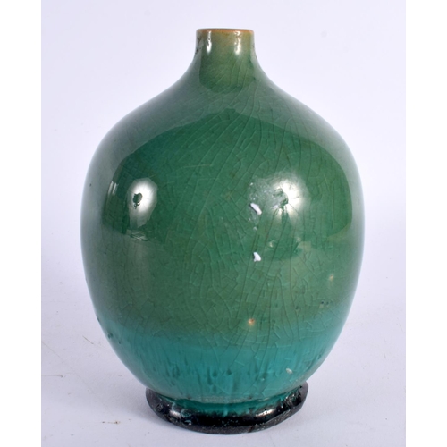 69 - A STUDIO POTTERY HIGH FIRED PORCELAIN GREEN GLAZED VASE. 15cm high.