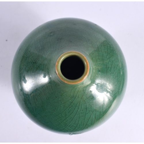 69 - A STUDIO POTTERY HIGH FIRED PORCELAIN GREEN GLAZED VASE. 15cm high.