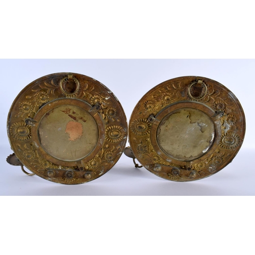 695 - A STYLISH PAIR OF ARTS AND CRAFTS BRASS REPOUSSE WALL HANGINGS decorated with foliage. 30cm x 22cm.