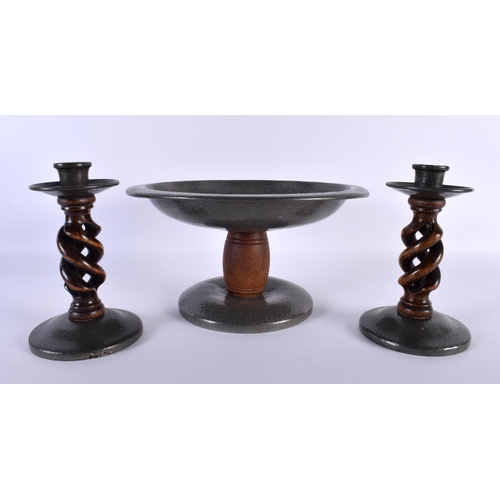 696 - AN ART DECO TUDRIC PEWTER HAMMERED COMPORT together with a matching pair of candlesticks. Largest 24... 