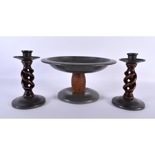 696 - AN ART DECO TUDRIC PEWTER HAMMERED COMPORT together with a matching pair of candlesticks. Largest 24... 