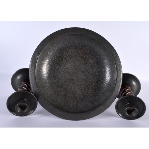 696 - AN ART DECO TUDRIC PEWTER HAMMERED COMPORT together with a matching pair of candlesticks. Largest 24... 