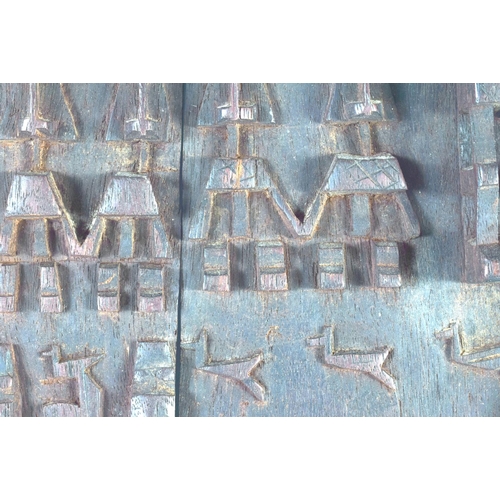 697 - AN AFRICAN TRIBAL CARVED WOOD DOGON DOOR depicting figures and animals. 52 cm x 38 cm.