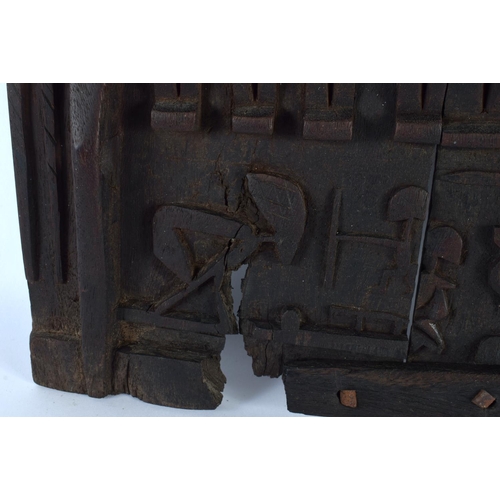 697 - AN AFRICAN TRIBAL CARVED WOOD DOGON DOOR depicting figures and animals. 52 cm x 38 cm.