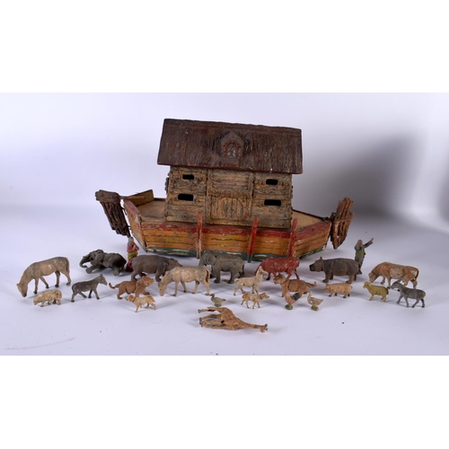 700 - AN EARLY 20TH CENTURY FOLK ART CARVED AND PAINTED WOOD NOAH'S ARK together with toys. Largest 40 cm ... 