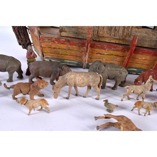 700 - AN EARLY 20TH CENTURY FOLK ART CARVED AND PAINTED WOOD NOAH'S ARK together with toys. Largest 40 cm ... 