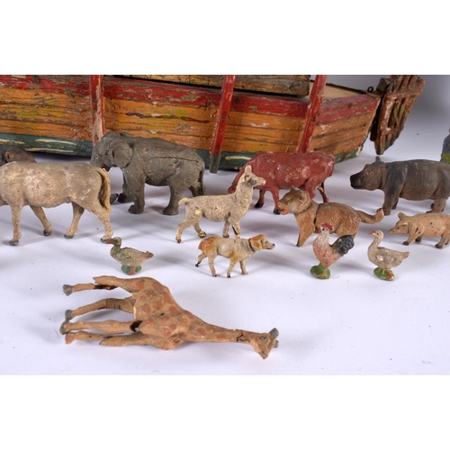 700 - AN EARLY 20TH CENTURY FOLK ART CARVED AND PAINTED WOOD NOAH'S ARK together with toys. Largest 40 cm ... 