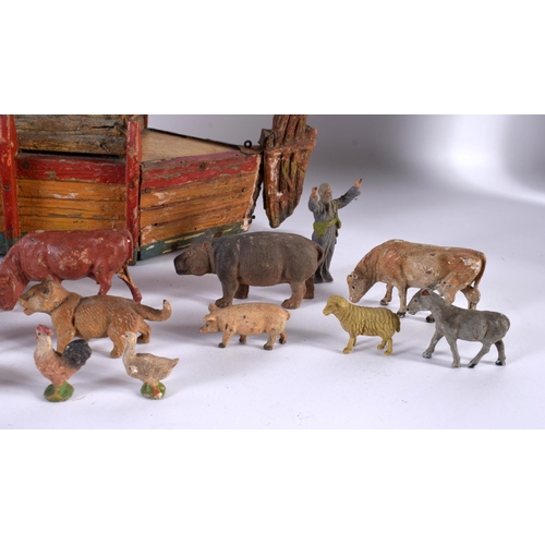 700 - AN EARLY 20TH CENTURY FOLK ART CARVED AND PAINTED WOOD NOAH'S ARK together with toys. Largest 40 cm ... 