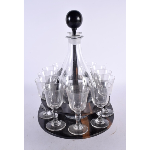 73 - AN ANTIQUE LIGNUM VITAE GLASS DECANTER SET with glasses. 30cm x 24 cm. (qty)