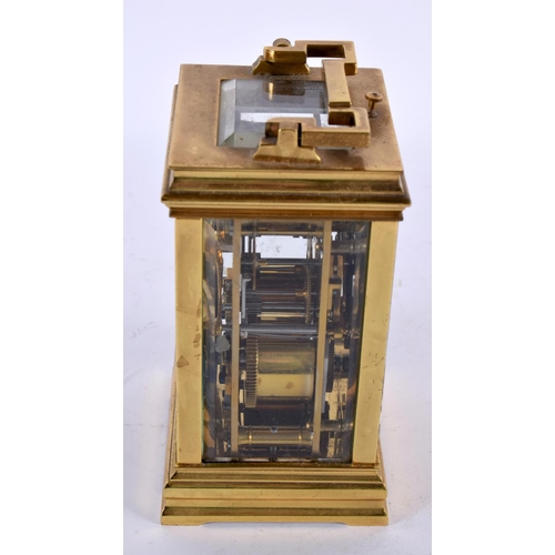 734 - AN ANTIQUE REPEATING BRASS CARRIAGE CLOCK. 18cm high inc handle.