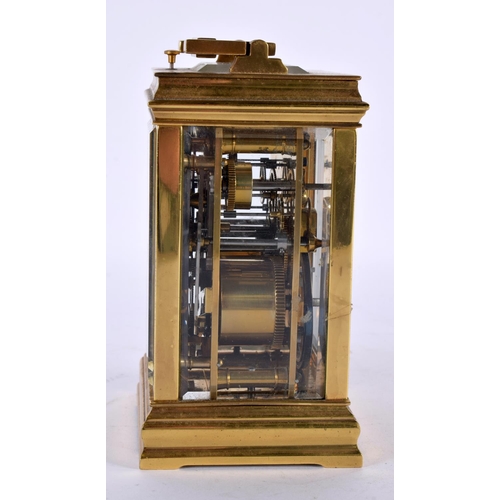 734 - AN ANTIQUE REPEATING BRASS CARRIAGE CLOCK. 18cm high inc handle.