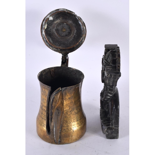 744 - A 19TH CENTURY INDIAN CARVED STONE FIGURE together with a Middle Eastern brass coffee pot. Largest 2... 