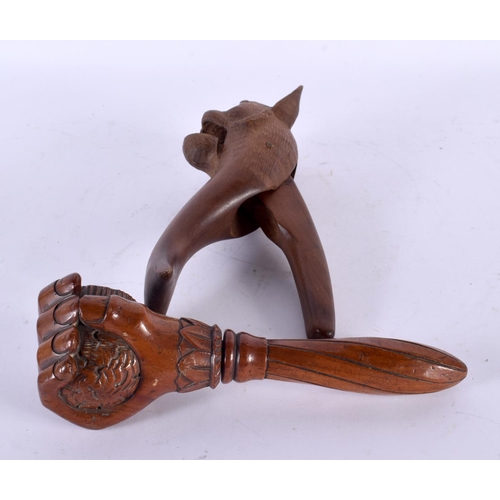 752 - A PAIR OF ANTIQUE BAVARIAN CARVED WOOD NUT CRACKERS together with another fist nutcracker. Largest 1... 