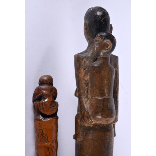 757 - AN EARLY 20TH CENTURY TRIBAL CARVED WOOD STAFF together with a Japanese bamboo walking cane. Largest... 