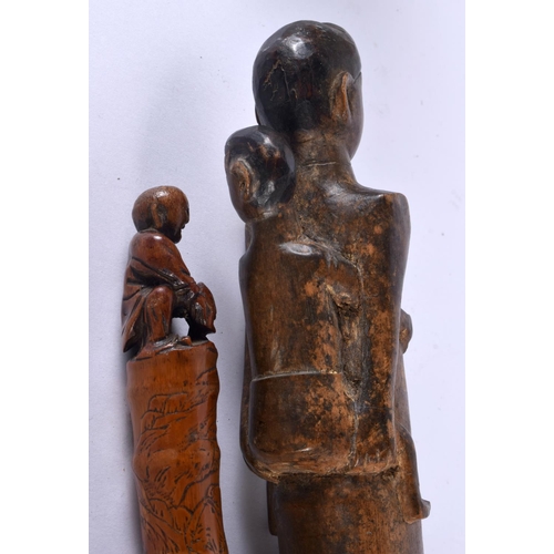 757 - AN EARLY 20TH CENTURY TRIBAL CARVED WOOD STAFF together with a Japanese bamboo walking cane. Largest... 