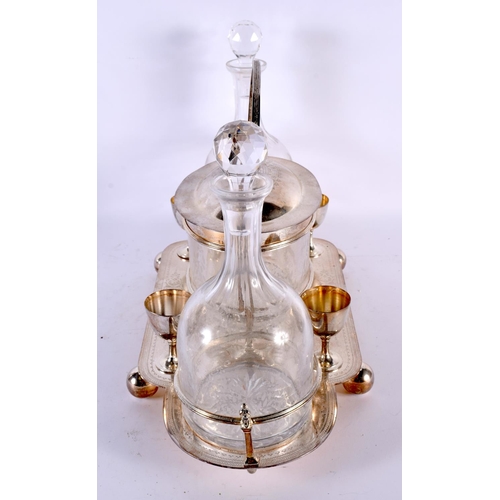 767 - A LARGE SILVER PLATED TWIN BOTTLE TANTALUS with barrel and goblets. 34 cm x 30cm.