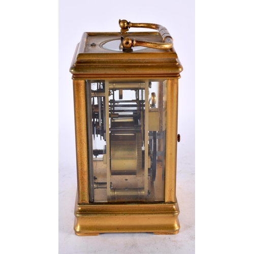 799 - AN ANTIQUE FRENCH REPEATING BRASS CARRIAGE CLOCK with enamel dial. 17 cm high inc handle.