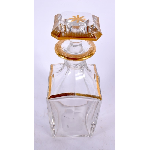 81 - AN ANTIQUE GILDED GLASS DECANTER AND STOPPER. 21 cm high.