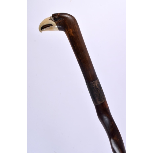 827 - AN ANTIQUE CARVED WOOD AND BONE PARROT WALKING CANE. 80 cm long.