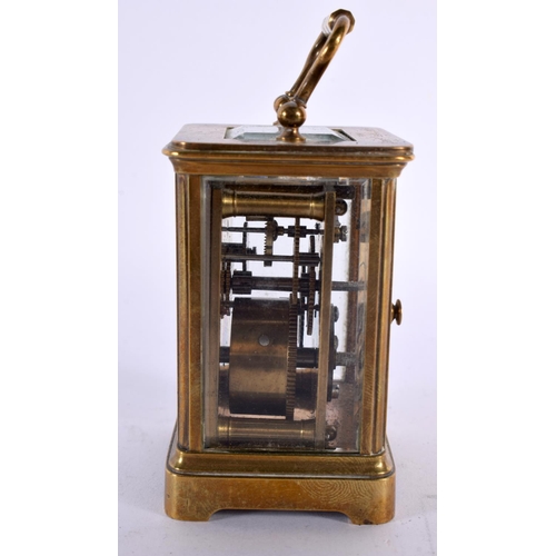 829 - A MINIATURE ANTIQUE CARRIAGE CLOCK. 9.5 cm high inc handle.