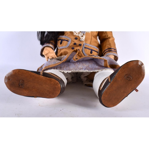 854 - A FINE SIMON HALBIG BISQUE HEADED PORCELAIN DOLL wearing original mustard clothing. 65 cm long.