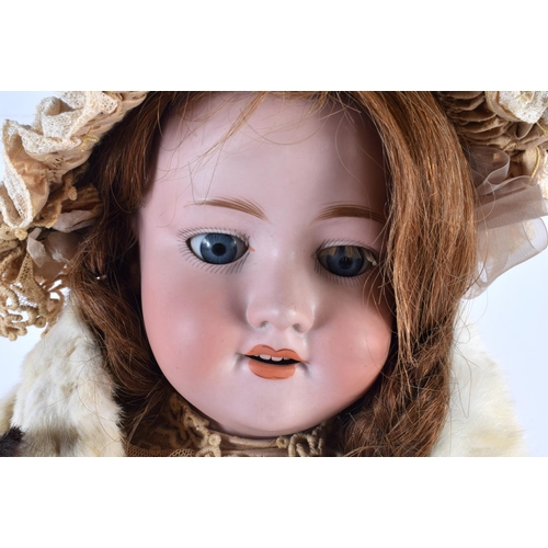 855 - A FINE ARMAND MARSEILLE BISQUE HEADED PORCELAIN DOLL wearing an embroidered neck collar and beige dr... 