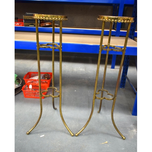 865 - A LARGE PAIR OF ARTS AND CRAFTS BRASS DISPLAY STANDS. 90cm high.