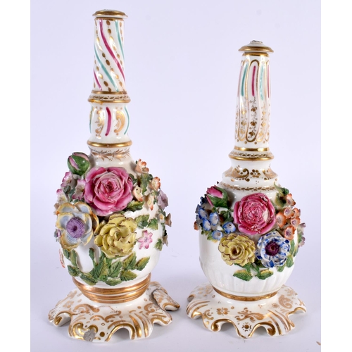 94 - A PAIR OF EARLY 19TH CENTURY ENGLISH PORCELAIN SCENT BOTTLES AND STOPPERS modelled encrusted with fl... 