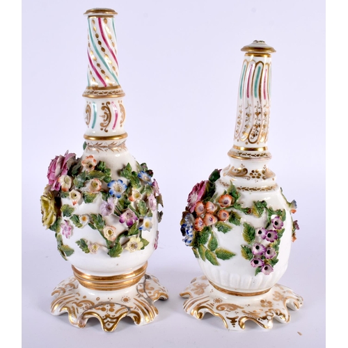 94 - A PAIR OF EARLY 19TH CENTURY ENGLISH PORCELAIN SCENT BOTTLES AND STOPPERS modelled encrusted with fl... 