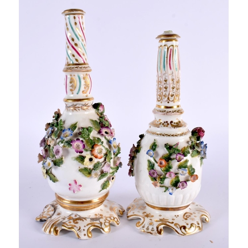 94 - A PAIR OF EARLY 19TH CENTURY ENGLISH PORCELAIN SCENT BOTTLES AND STOPPERS modelled encrusted with fl... 