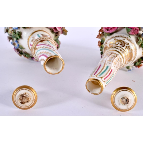 94 - A PAIR OF EARLY 19TH CENTURY ENGLISH PORCELAIN SCENT BOTTLES AND STOPPERS modelled encrusted with fl... 