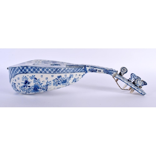 97 - AN ANTIQUE DELFT BLUE AND WHITE MUSICAL INSTRUMENT painted with flowers. 40 cm long.