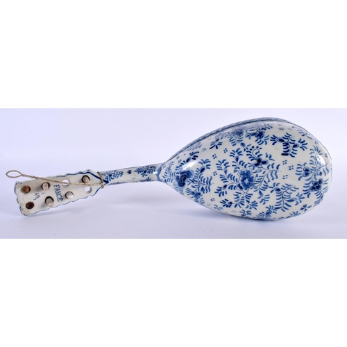 97 - AN ANTIQUE DELFT BLUE AND WHITE MUSICAL INSTRUMENT painted with flowers. 40 cm long.