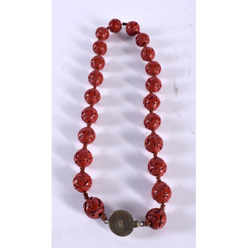 1006 - A CHINESE CARVED CINNABAR LACQUER NECKLACE. 27 grams. 47 cm long.