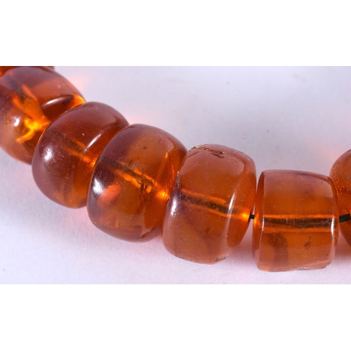 1008 - AN AMBER NECKLACE. 134 grams. 48 cm long.