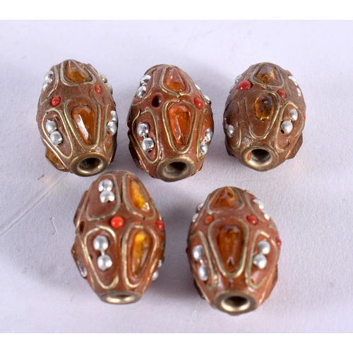 1013 - FIVE UNUSUAL PEARL CORAL NUT AND AMBER BEADS possibly Ottoman. 18.6 grams. 2 cm x 1.25 cm. (5)