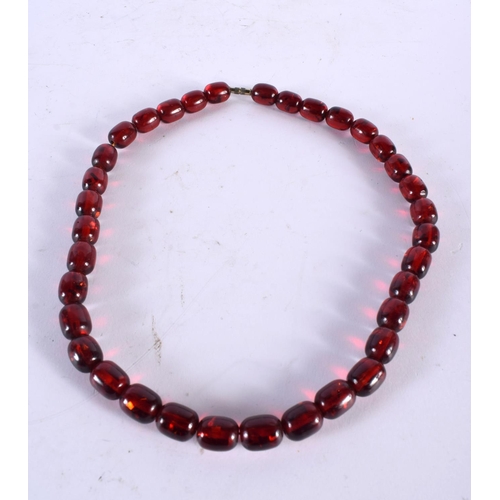 1014 - A CHERRY AMBER TYPE BEAD NECKLACE. 53 grams. 68 cm long.