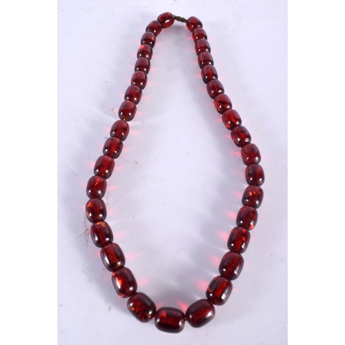 1014 - A CHERRY AMBER TYPE BEAD NECKLACE. 53 grams. 68 cm long.