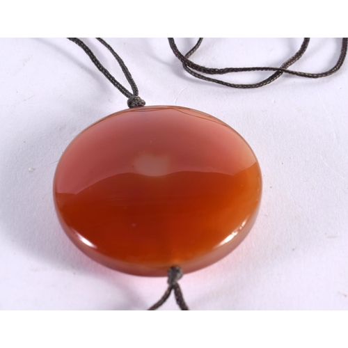 1034 - A CHINESE CARVED AGATE NECKLACE. 36.2 grams. 4.25 cm diameter.