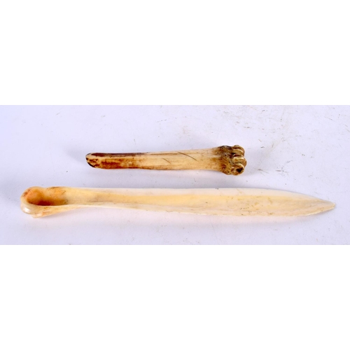 1054 - AN ANTIQUE CARVED BONE TRIBAL MARROW SCOOP together with a carved scrimshaw letter opener. 52 grams.... 