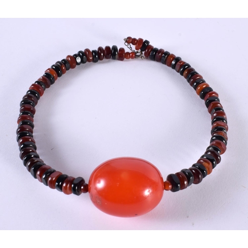 1055 - A CHERRY AMBER TYPE NECKLACE. 51.7 grams. Largest bead 4 cm x 3 cm.