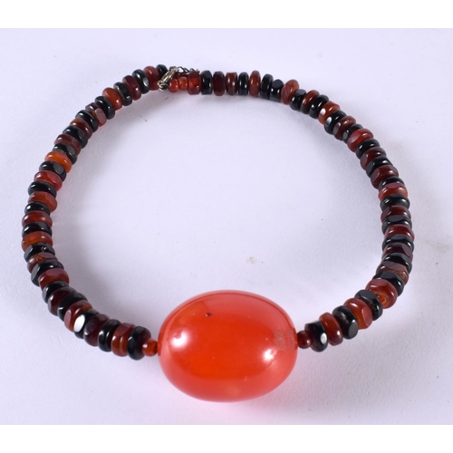 1055 - A CHERRY AMBER TYPE NECKLACE. 51.7 grams. Largest bead 4 cm x 3 cm.