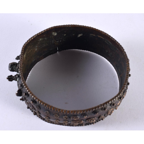 1064 - AN ANTIQUE TIBETAN MIDDLE EASTERN INDIAN NEPALESE BRONZE BANGLE decorated with buddhistic figures. 1... 