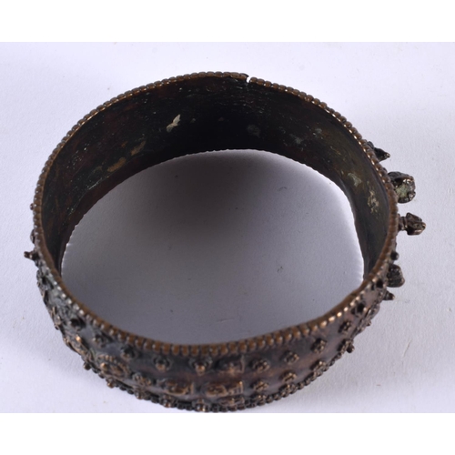 1064 - AN ANTIQUE TIBETAN MIDDLE EASTERN INDIAN NEPALESE BRONZE BANGLE decorated with buddhistic figures. 1... 