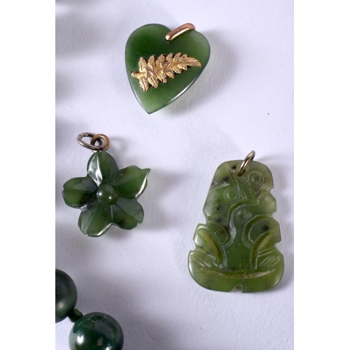 1079 - A CHINESE GOLD MOUNTED JADE PENDANT together with other jade jewelry. 130 grams. Largest 55 cm long.... 