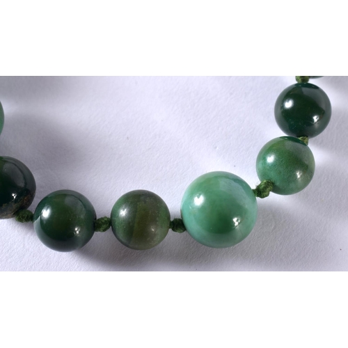 1079 - A CHINESE GOLD MOUNTED JADE PENDANT together with other jade jewelry. 130 grams. Largest 55 cm long.... 