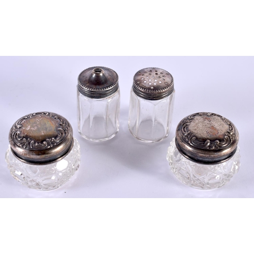 1100 - FOUR SILVER MOUNTED JARS. Birmingham 1907 etc. Largest 3.5 cm x 3 cm. (4)